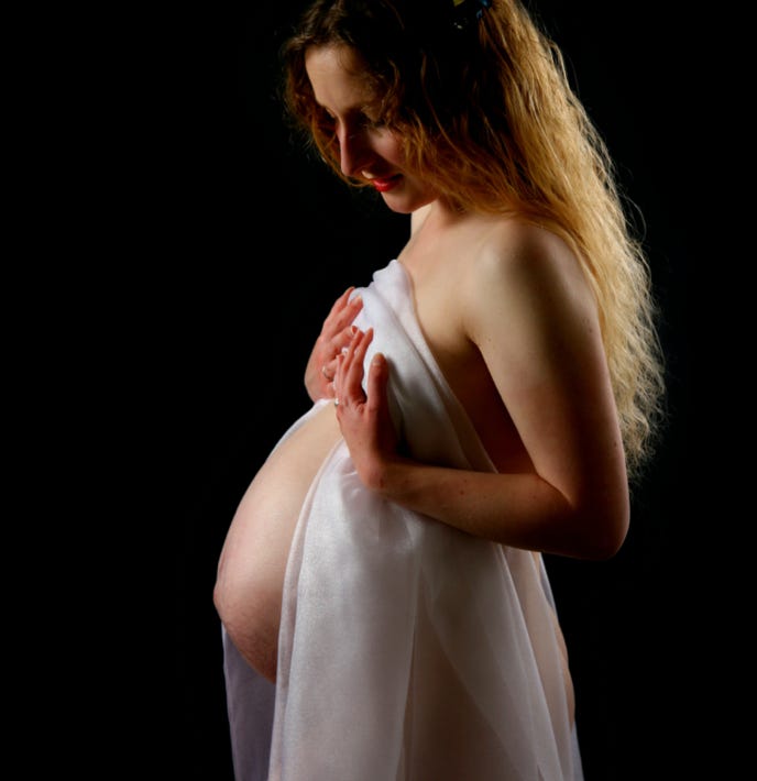 Baby Bump photo by Jayne Poole on a black background showing of the beauty off your body during pregnancy loacted in Devon, near Barnstaple, Bidforde, South Molton, Holsworthy and Bude. Jayne will put you at ease and provide the images that you will treasure for a liftime